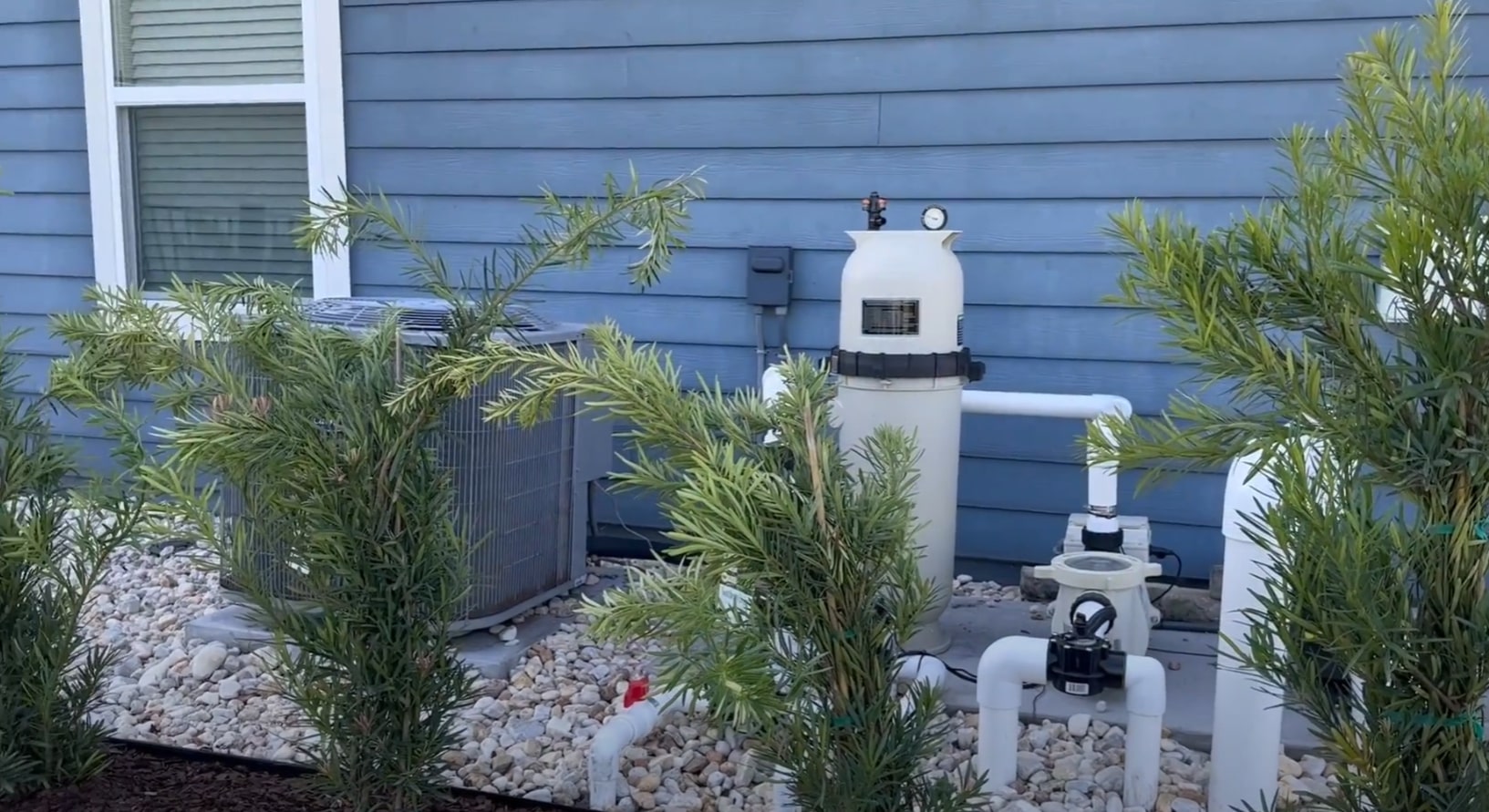 Behind-the-scenes landscape maintenance equipment and professional irrigation systems Professional pool equipment and landscape maintenance setup with proper screening